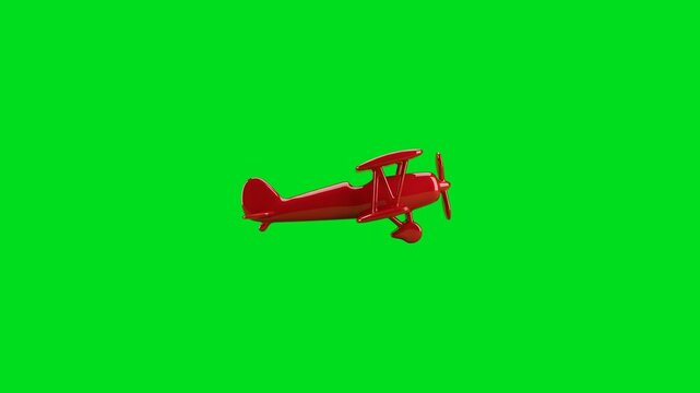 A shiny red biplane toy isolated against a vibrant solid green background