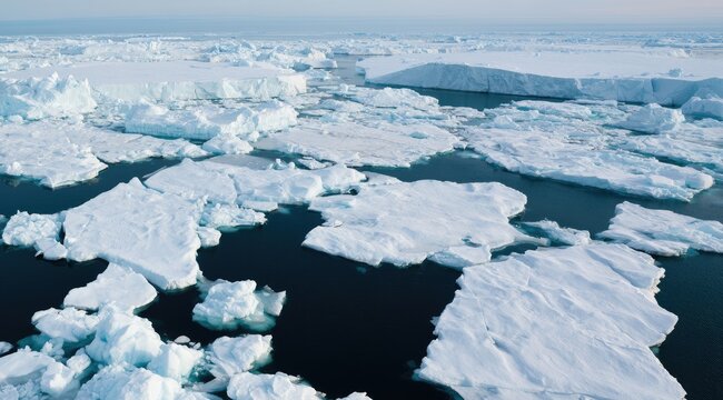 Vast expanse of fragmented ice floes floating on dark, deep water
