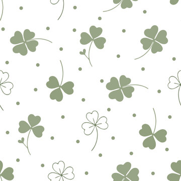 Cute sage green clover leaf and polka dot seamless pattern on white background. Sweet four leaf clover, shamrock, and green dots hand drawn vector illustration.