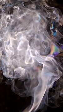 Abstract White Smoke Wisps Rising on Dark Background - Ethereal white smoke billows and swirls upwards against a deep black void, creating abstract, organic shapes with delicate light and shadow play.