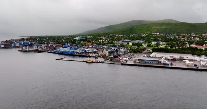Sortland in Northern Norway, showing a coastal harbour with low cloud, buildings, fjord scenery and waterfront infrastructure in the Vestera&aring;len region, aerial view