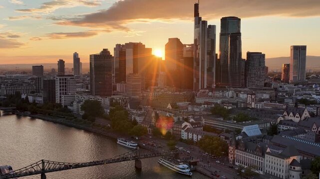 Sunset over Frankfurt Skyline In Hesse Germany. Highrise Buildings. Sunset Downtown. Meno River Scenery. Frankfurt Skyline In Frankfurt In Hesse Germany. Travel Destination. Europe Skyline.