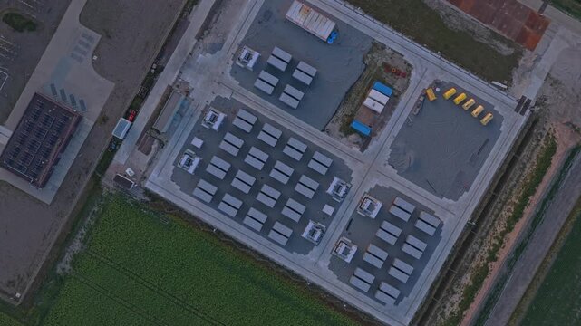High angle rotating view of a large scale bess, a modern energy storage solution facility under construction for renewable power grid stability