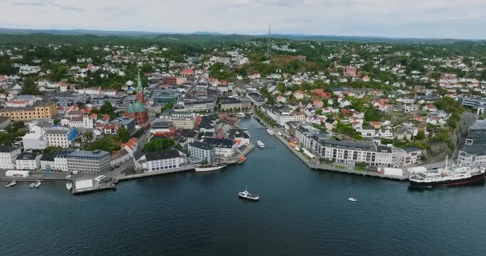 Aerial view of Arendal harbor town Norway coastal city in slow motion