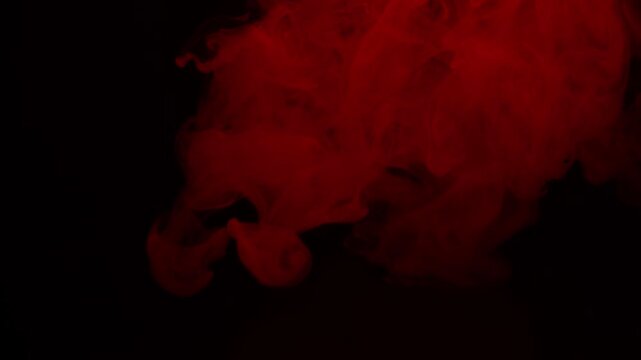 Real Red Smoke on Black Background