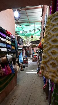 Marrakech, morocco. August 8, 2026. Point of view walking through a traditional moroccan market alley. Colorful handcrafted goods and local crafts for sale in the vibrant souk