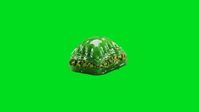 A single piece of vibrant green pistachio baklava on a bright green background