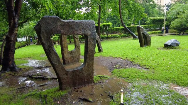Wet Garden Stone Sculpture Surrounded by Fresh Green Grass