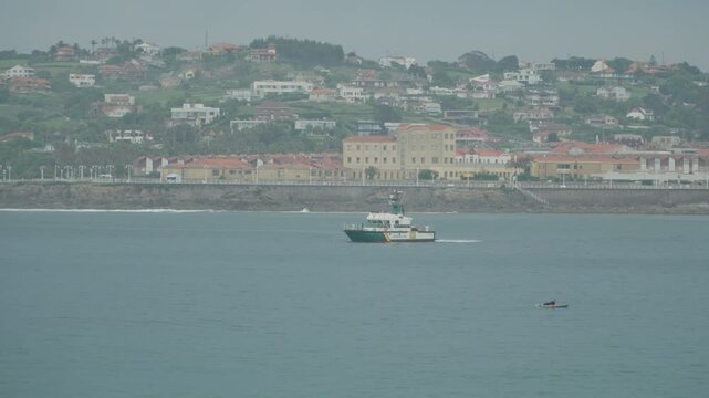 Guardia Civil maritime patrol vessel navigating along the coast near San Lorenzo beach