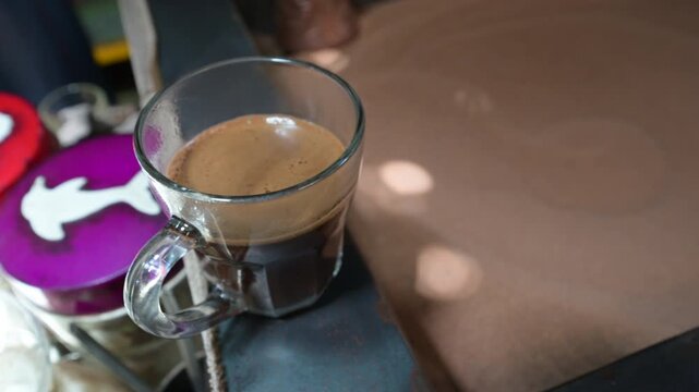 Marrakech, morocco. August 8, 2026. Traditional nous nous coffee brewing in a glass cup at a local cafe in marrakech, morocco. Delicious hot beverage prepared in the souk