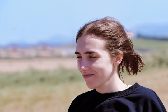 A beautiful girl in a blue jacket on the nature