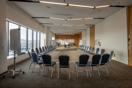 Empty conference room with chairs arranged in a circle for team workshop