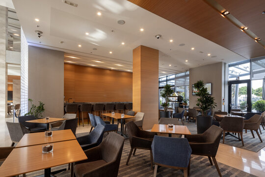 Modern hotel restaurant and lounge bar interior with stylish tables and armchairs