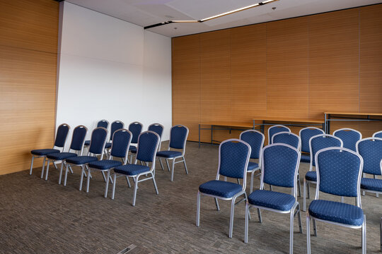 Empty presentation room in a hotel with blue chairs arranged in rows
