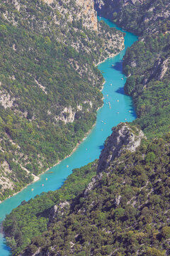 The Verdon river with little canoes navigating in the canyon, seen from the viewpoint of the cirque de Vaumale