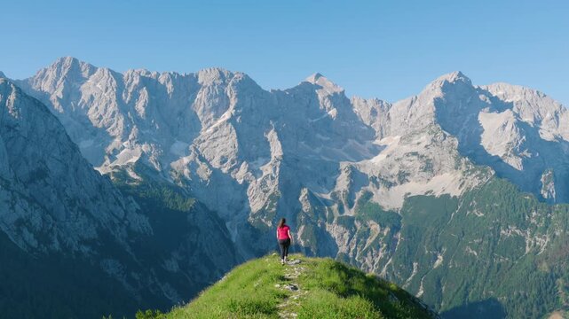 Hiker Walking Towards Scenic Ridge Of Goli Vrh Viewpoint In The Kamnik-savinja Alps Of Slovenia. - wide shot