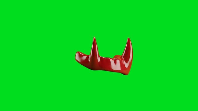 A shiny red glossy devil horn accessory isolated on a vibrant green screen