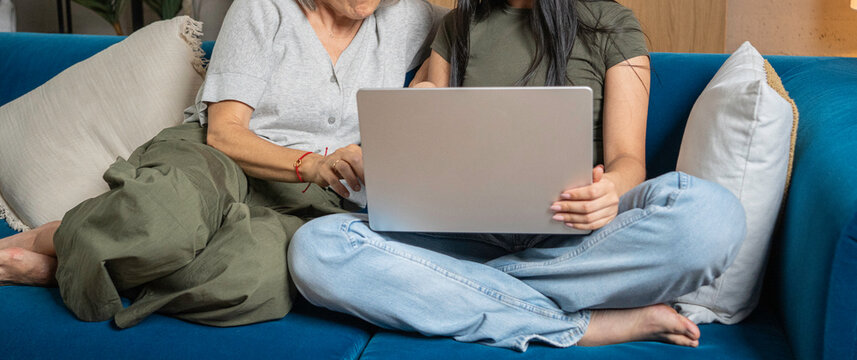 Mother and daughter bonding while learning digital skills on a laptop