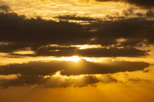 The sun is shining through the clouds