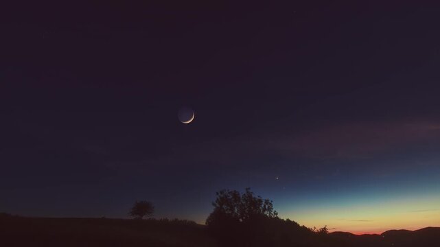 Crescent Moon, planet conjunction and landscape scenery silhouettes. Time-lapse video.