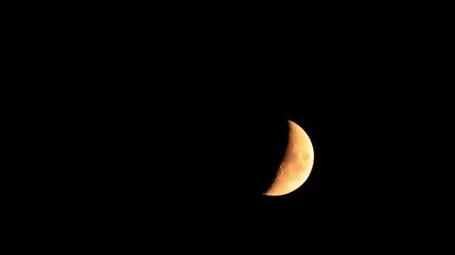 Half Moon on a dark night sky.