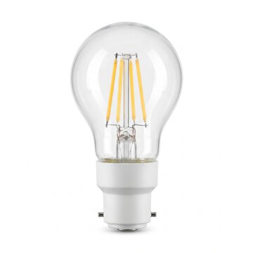 Clear glass light bulb with a white bayonet base standing upright, isolated on a white background