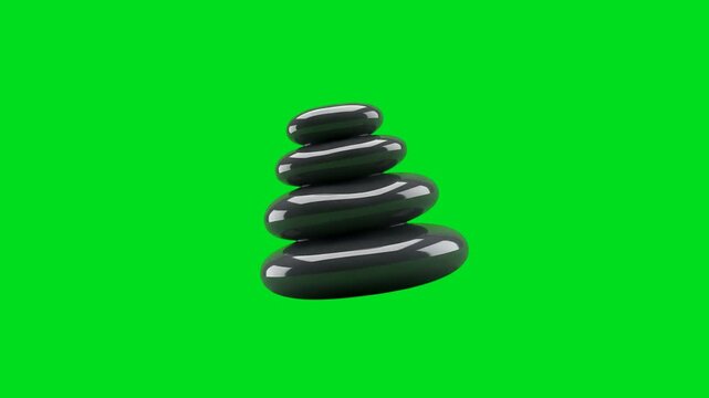A stack of four smooth polished black zen stones on a vibrant green screen