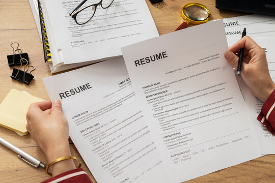 Human Resources Specialist Comparing Job Applicant Resumes