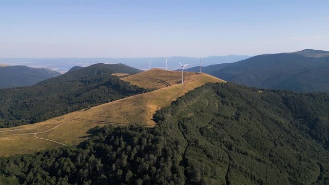 Aerial View of Wind Turbines Windmill Farm on Mountain Ridge at Sunset