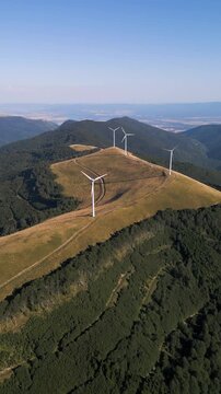 Aerial View of Wind Turbines Windmill Farm on Mountain Ridge at Sunset