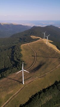 Aerial View of Wind Turbines Windmill Farm on Mountain Ridge at Sunset