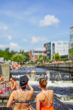 People enjoying summer day swimming in Akerselva Nydalen Oslo