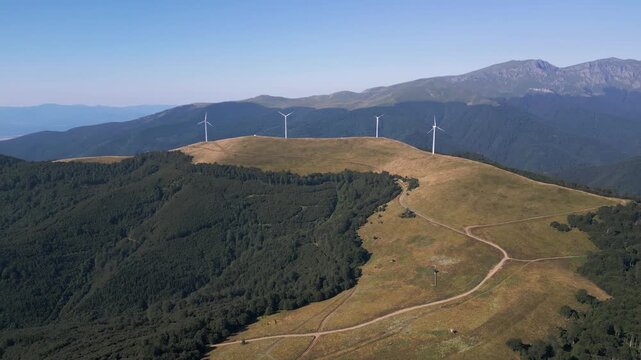 Aerial View of Wind Turbines Windmill Farm on Mountain Ridge at Sunset