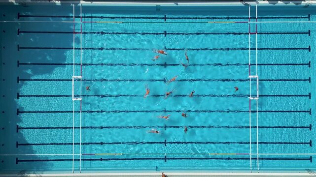 Top Down Aerial View of Water Polo Match Sprint Start Swimming to Center Ball