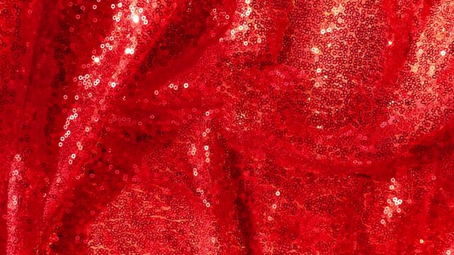 Sparkling Red Sequin Fabric Waves as Holiday Background.red shimmer celebration background.Sparkling Sequin Fabric Waves as Holiday Background
