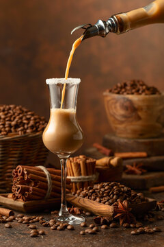 Irish cream and coffee liqueur is poured from a bottle into a glass.