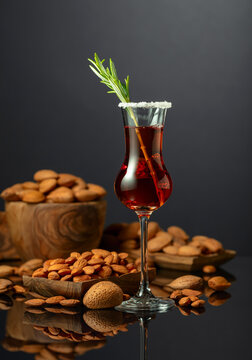 Italian liqueur Amaretto with almonds nuts on a black background.