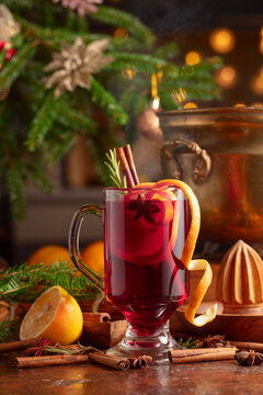 Christmas mulled wine with spices, citrus, and vintage kitchen utensils.