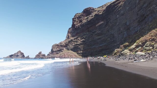 People Walking on Black Sand Beach at Playa de Nogales in La Palma