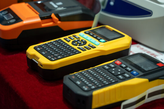 Several Portable Handheld Electronic Devices Displayed on Red Surface