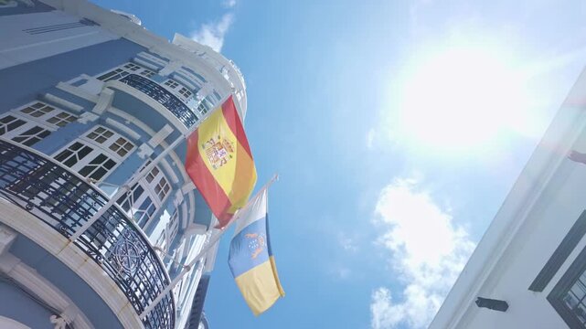 Spanish and Canary Islands flags on historic building facade