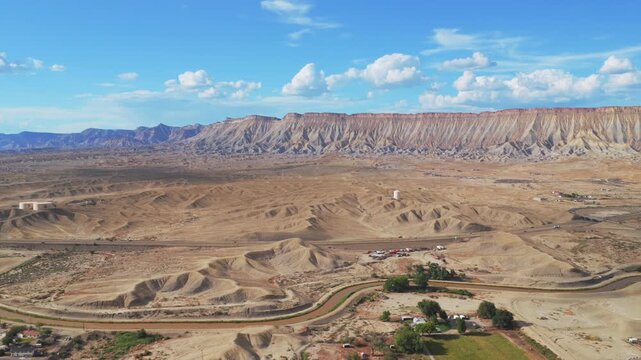 Colorado River Book Cliffs high desert Mesa Clifton Grand Junction aerial drone Colorado sunny afternoon summer blue sky clouds Grand Mesa Parachute Fruita Loma Delta i70 cars backwards upwards