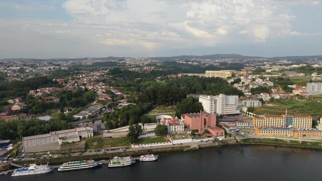 Aerial - Douro River quay at Freixo with cruise boats warehouses and hillside housing