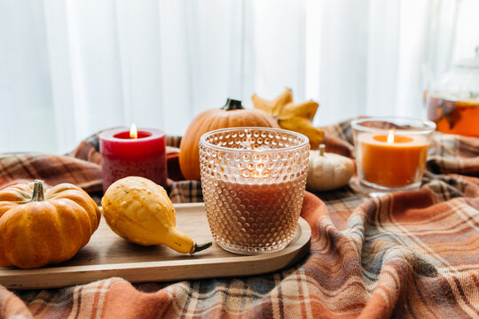 Cozy autumn still life with pumpkins and burning candles
