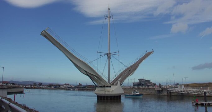 Wide shot of Pont y Ddraig, Dragon's Bridge opening up at Rhyl harbour.