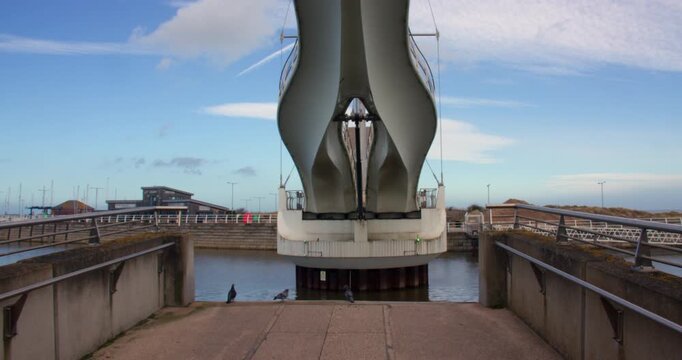 End on shot of Pont y Ddraig, Dragon's Bridge opening up at Rhyl harbour.