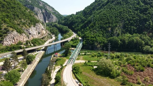 Ovcar Banja, Serbia. Establishing Drone Shot of Road and Bridge Traffic, Zapadna Morava River Gorge on Sunny Summer Day