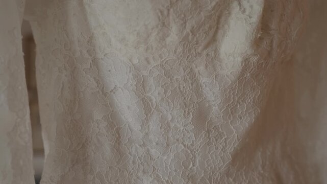 Bridal Lace Gown Fabric Close Up With Floral Embroidery Folds And Soft Warm Window Light