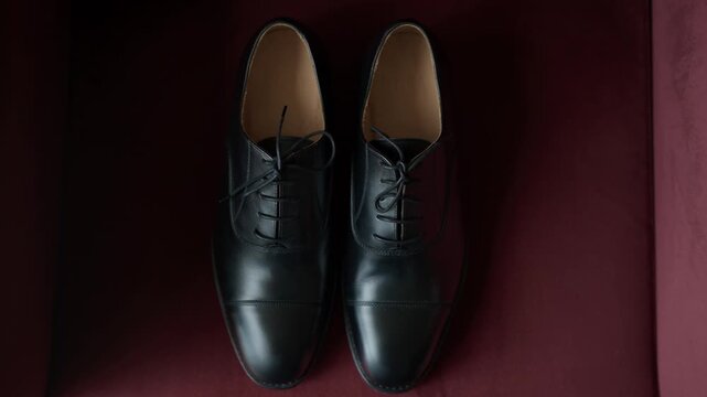 Black Leather Dress Shoes Side By Side On Deep Red Fabric With Laces And Tan Lining