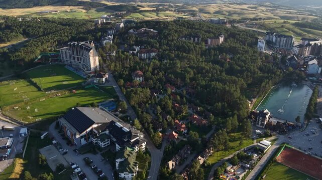 Aerial View of Zlatibor Mountain Resort, Serbia on Sunny Summer Evening, Buildings and Pine Forest Above Lake